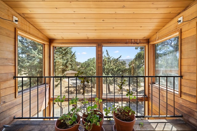 unfurnished sunroom with wooden ceiling and vaulted ceiling