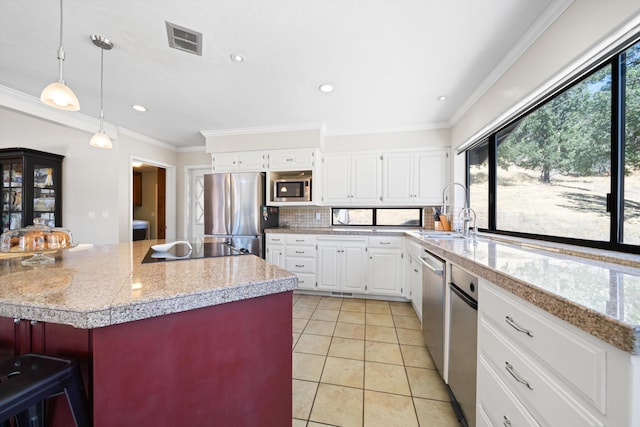 kitchen featuring a kitchen island with sink, sink, light tile patterned floors, white cabinetry, and stainless steel appliances