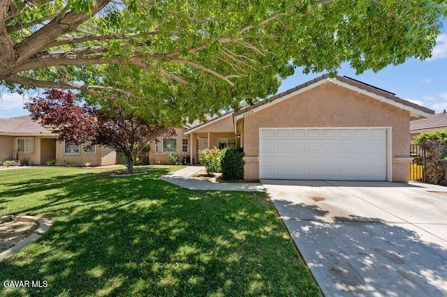 43656 E 5th St, Lancaster, CA 93535 - ranch-style house with stucco siding, concrete driveway, a garage, and a front lawn