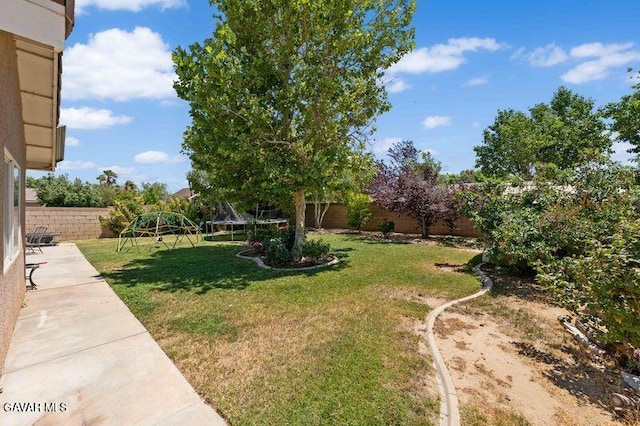 43656 E 5th St, Lancaster, CA 93535 - fenced backyard with a trampoline, a patio area, and a playground