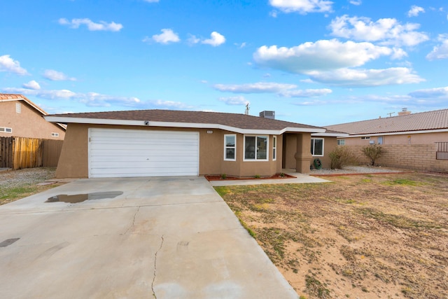 single story home with a garage, fence, driveway, and stucco siding