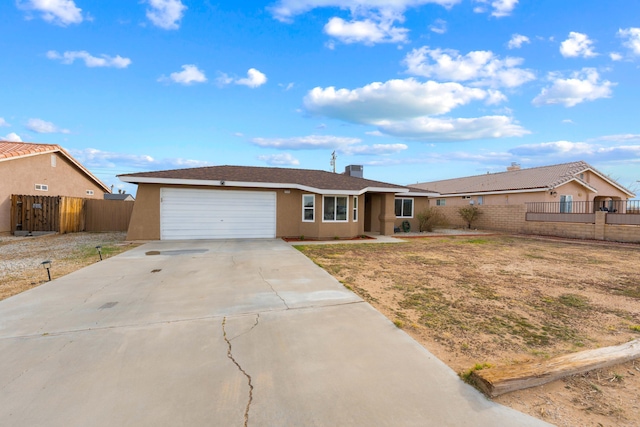 single story home featuring fence, driveway, an attached garage, and stucco siding