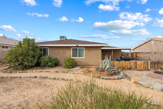 view of home's exterior with fence and stucco siding