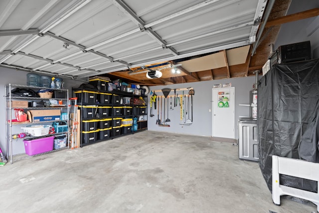 garage featuring water heater and a garage door opener