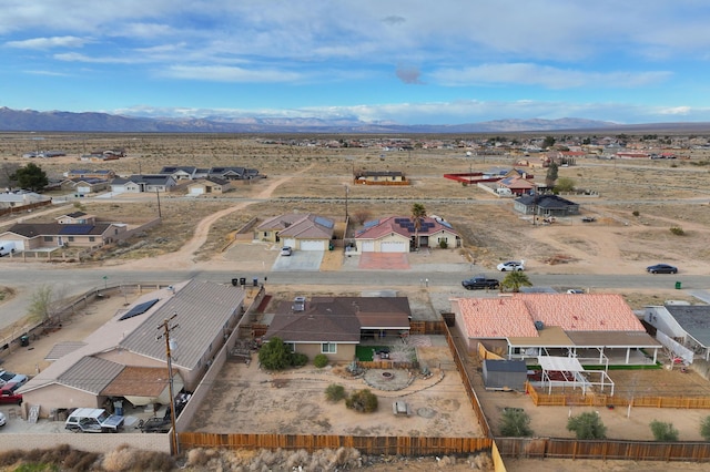 bird's eye view with a residential view, view of desert, and a mountain view