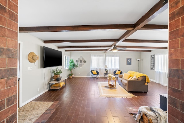 living room with beamed ceiling, ceiling fan, and dark hardwood / wood-style floors