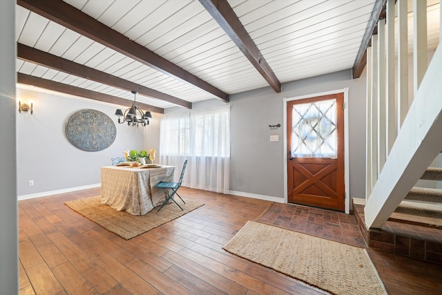 foyer with a chandelier, beam ceiling, and hardwood / wood-style flooring