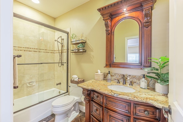 full bathroom with vanity, toilet, and bath / shower combo with glass door