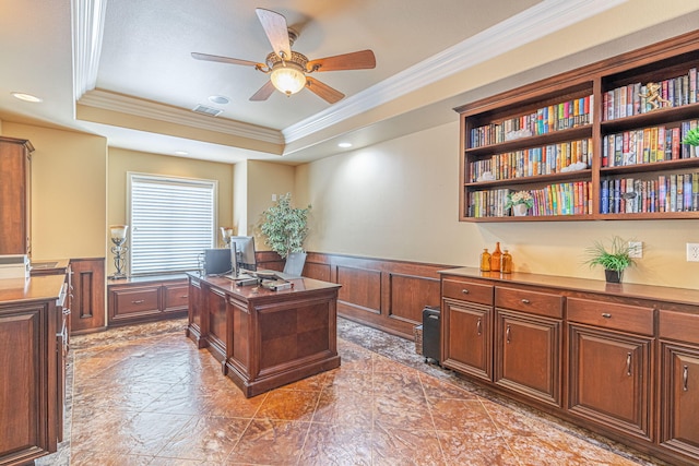 home office with a raised ceiling, crown molding, and ceiling fan