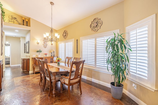 dining room featuring a chandelier and vaulted ceiling