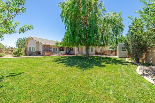 view of yard with a patio and a storage unit