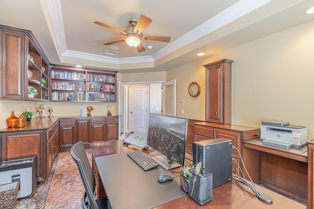 office area with a tray ceiling, ceiling fan, and ornamental molding