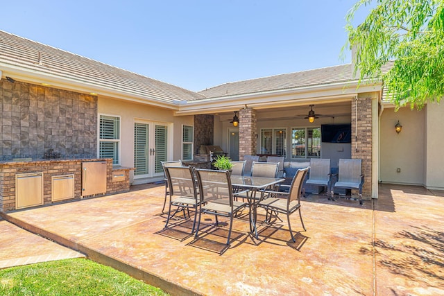 view of patio / terrace featuring an outdoor kitchen and ceiling fan