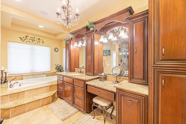 bathroom with vanity, a raised ceiling, tiled bath, and an inviting chandelier