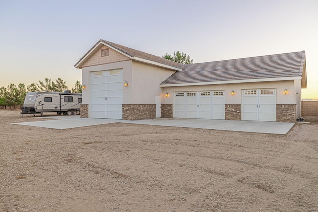 view of garage at dusk