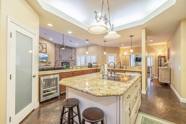 kitchen featuring a breakfast bar, wine cooler, hanging light fixtures, and a spacious island