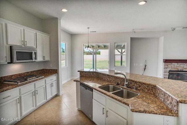 41729 Firenze St, Lancaster, CA 93536 - kitchen with stainless steel appliances, white cabinetry, a kitchen island with sink, decorative light fixtures, and recessed lighting