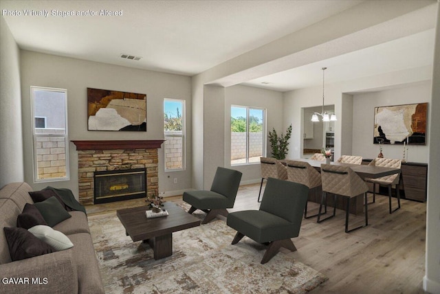 41729 Firenze St, Lancaster, CA 93536 - living room featuring a chandelier, light wood-style floors, and a fireplace
