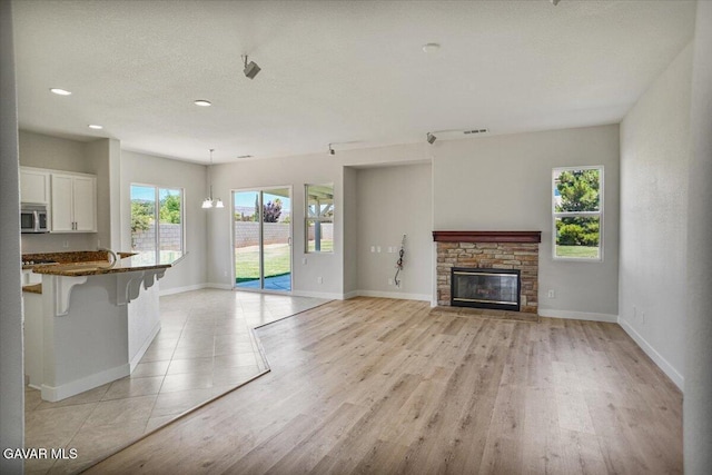 41729 Firenze St, Lancaster, CA 93536 - unfurnished living room featuring light wood-type flooring, a fireplace, and recessed lighting