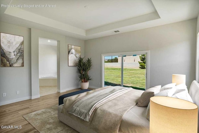 41729 Firenze St, Lancaster, CA 93536 - bedroom with a raised ceiling, wood finished floors, and connected bathroom