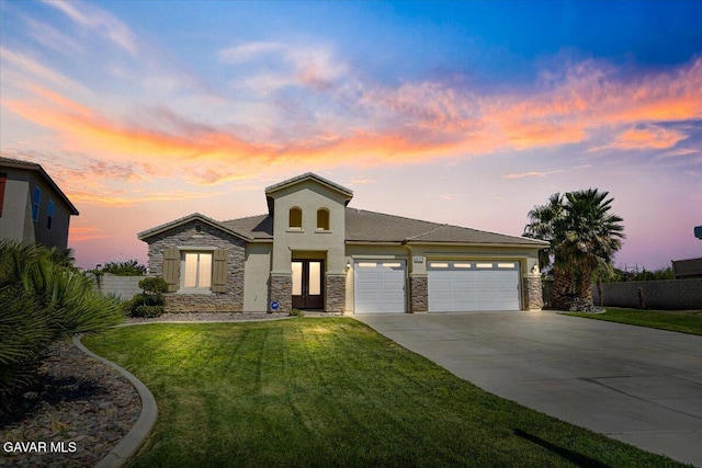 41729 Firenze St, Lancaster, CA 93536 - view of front of property with an attached garage, stone siding, driveway, and stucco siding