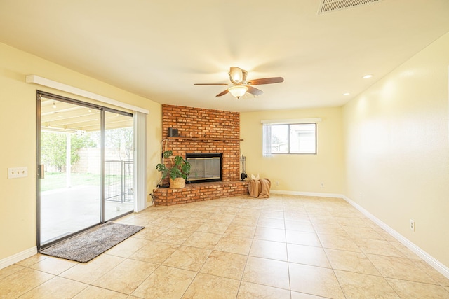 unfurnished living room with baseboards, ceiling fan, visible vents, and a wealth of natural light
