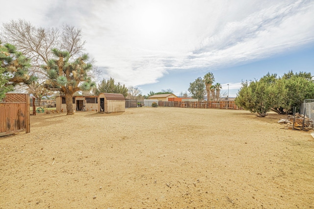 view of yard with an outdoor structure and a fenced backyard