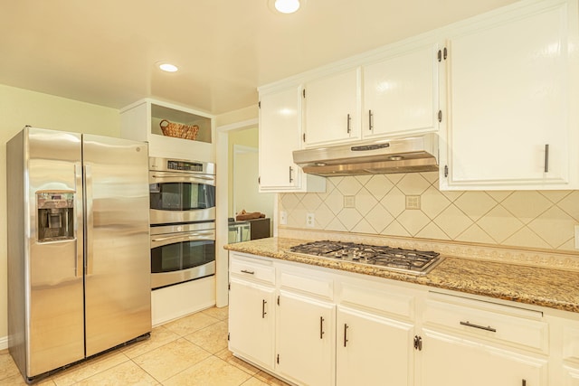 kitchen featuring recessed lighting, white cabinetry, under cabinet range hood, tasteful backsplash, and stainless steel appliances