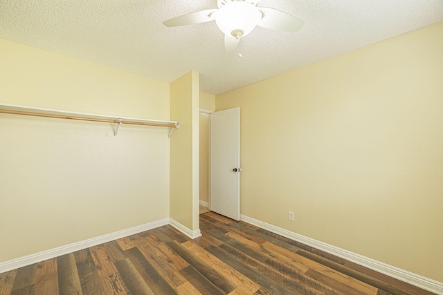 unfurnished bedroom featuring a textured ceiling, a ceiling fan, baseboards, dark wood-style floors, and a closet