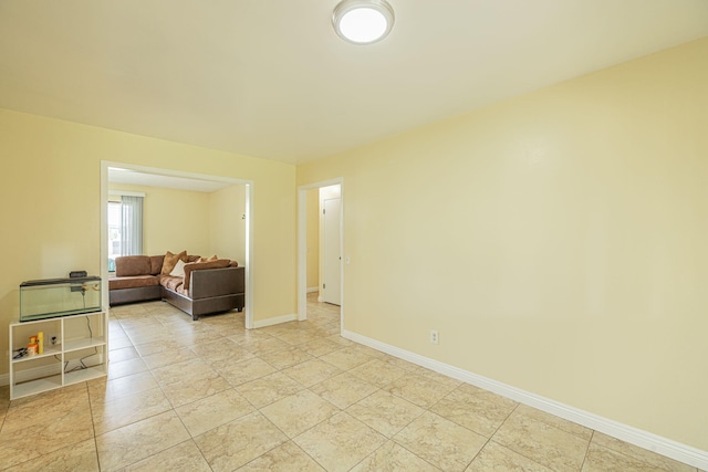 spare room with baseboards
