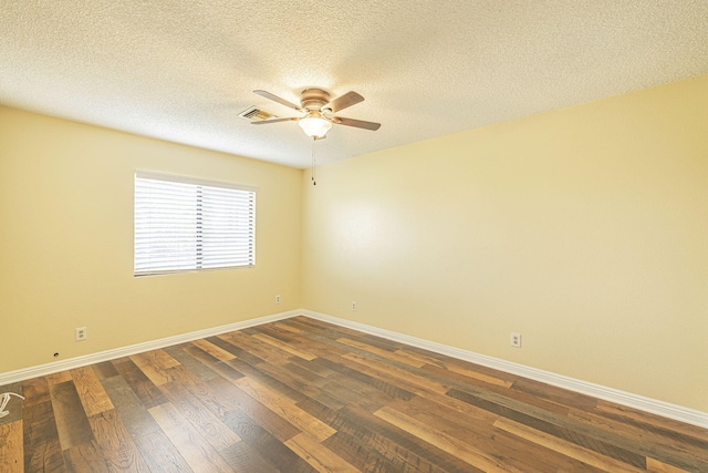 empty room with a ceiling fan, a textured ceiling, visible vents, baseboards, and dark wood-style floors