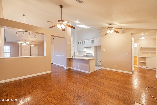 4068 Vancouver Ln, Quartz Hill, CA 93536 - kitchen featuring a ceiling fan, a peninsula, lofted ceiling, white cabinets, and stainless steel range oven