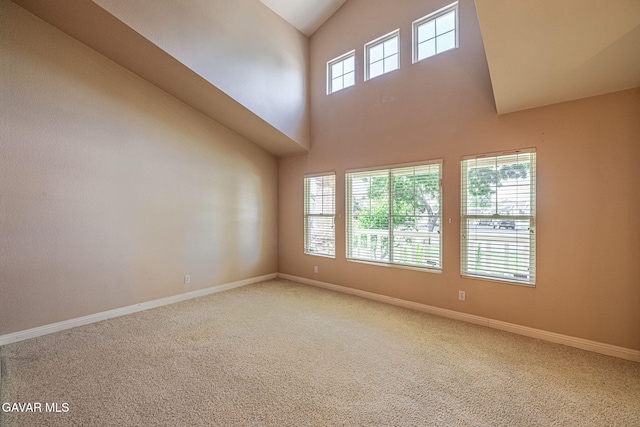 4068 Vancouver Ln, Quartz Hill, CA 93536 - carpeted empty room featuring high vaulted ceiling and baseboards