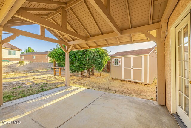4068 Vancouver Ln, Quartz Hill, CA 93536 - fenced backyard featuring a patio and a storage unit