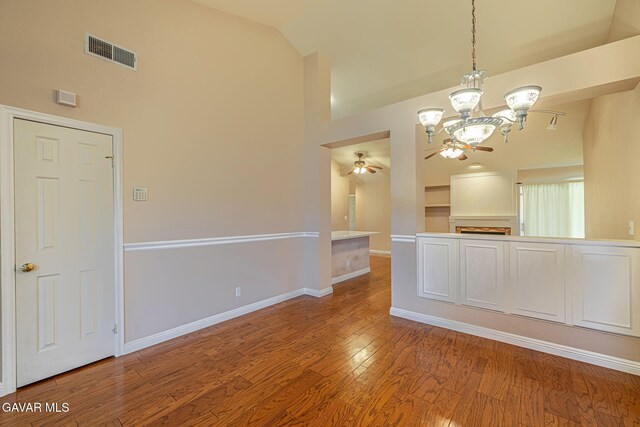 4068 Vancouver Ln, Quartz Hill, CA 93536 - unfurnished dining area with ceiling fan, a chandelier, wood finished floors, and high vaulted ceiling