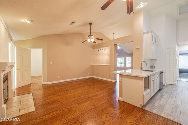 4068 Vancouver Ln, Quartz Hill, CA 93536 - kitchen with a ceiling fan, vaulted ceiling, light countertops, light wood-style flooring, and stainless steel dishwasher