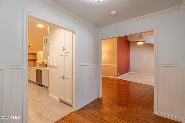 4068 Vancouver Ln, Quartz Hill, CA 93536 - hall featuring a wainscoted wall, ornamental molding, light wood-style flooring, and wooden walls