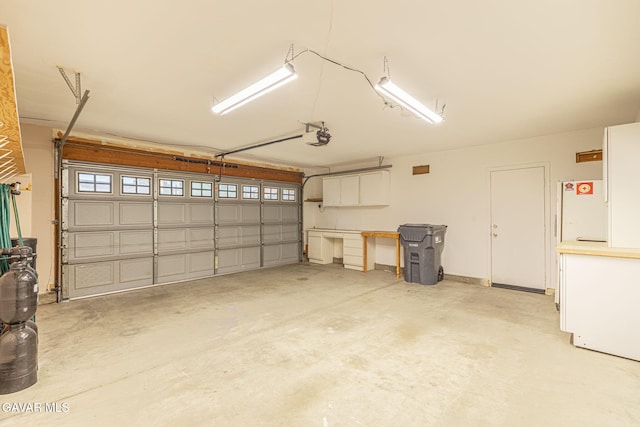 4068 Vancouver Ln, Quartz Hill, CA 93536 - garage with a garage door opener and freestanding refrigerator