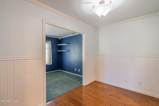 4068 Vancouver Ln, Quartz Hill, CA 93536 - empty room featuring wood finished floors, wainscoting, and crown molding