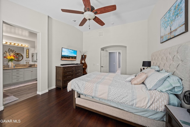42409 W 66th St, Lancaster, CA 93536 - bedroom with arched walkways, dark wood-style flooring, connected bathroom, and a ceiling fan