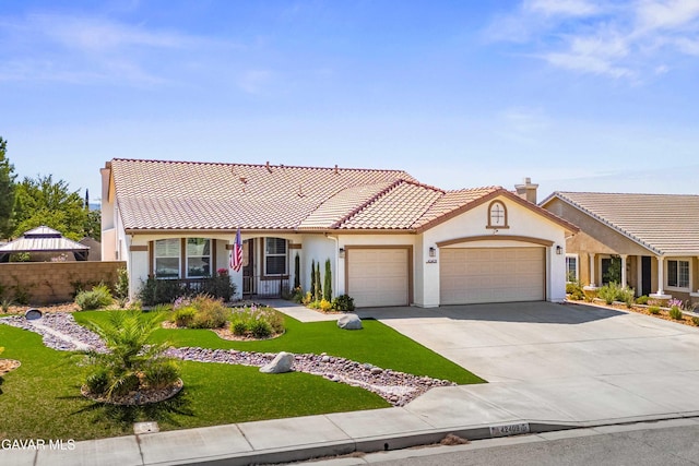 42409 W 66th St, Lancaster, CA 93536 - mediterranean / spanish-style home featuring stucco siding, concrete driveway, a garage, and a tiled roof