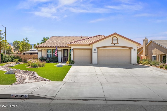 42409 W 66th St, Lancaster, CA 93536 - mediterranean / spanish-style home featuring an attached garage, stucco siding, a tile roof, driveway, and a front yard