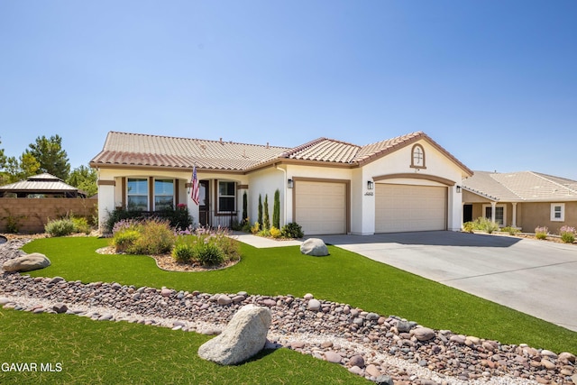 42409 W 66th St, Lancaster, CA 93536 - view of front facade featuring an attached garage, driveway, stucco siding, and a tiled roof