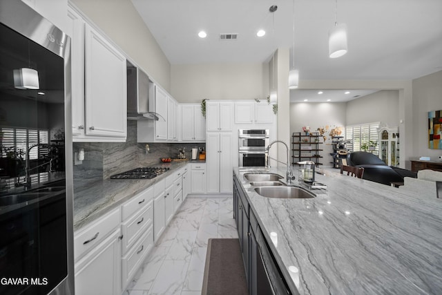 42409 W 66th St, Lancaster, CA 93536 - kitchen featuring wall chimney range hood, stainless steel appliances, light marble finish flooring, light stone counters, and recessed lighting