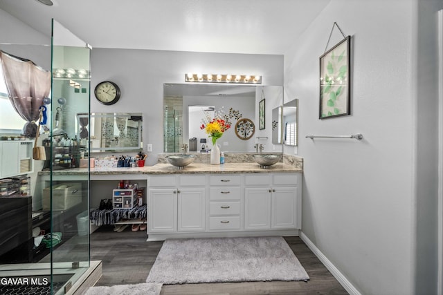 42409 W 66th St, Lancaster, CA 93536 - bathroom with wood finished floors, double vanity, and a stall shower
