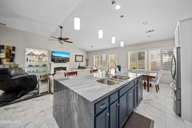 42409 W 66th St, Lancaster, CA 93536 - kitchen with light marble finish floors, appliances with stainless steel finishes, blue cabinets, lofted ceiling, and ceiling fan