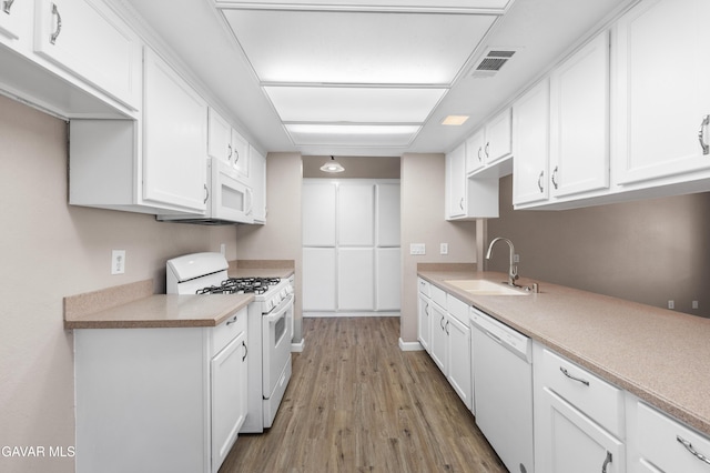 4633 Dowel Ave, Palmdale, CA 93552 - kitchen featuring white appliances, wood finished floors, white cabinetry, and light countertops