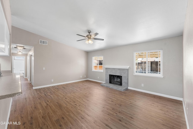 4633 Dowel Ave, Palmdale, CA 93552 - unfurnished living room with ceiling fan, wood finished floors, and a fireplace