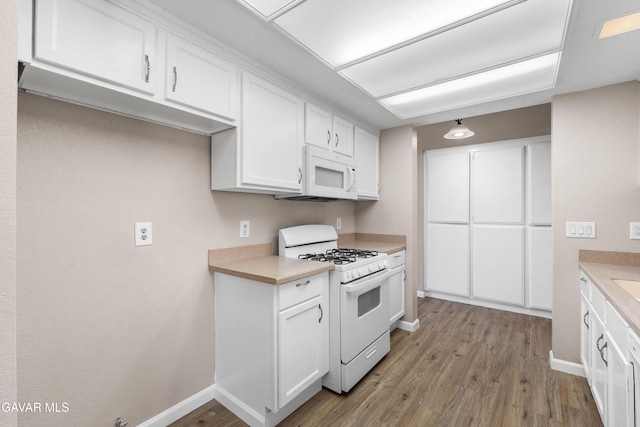 4633 Dowel Ave, Palmdale, CA 93552 - kitchen featuring white appliances, light wood finished floors, white cabinets, and light countertops