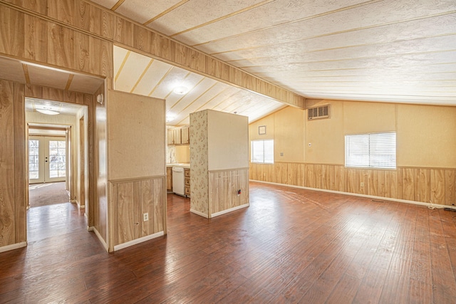 interior space with a wealth of natural light, french doors, hardwood / wood-style floors, and vaulted ceiling